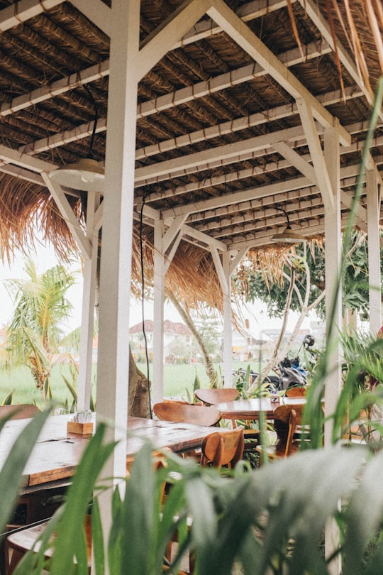 brown wooden tables and chairs in Canggu Indonesia