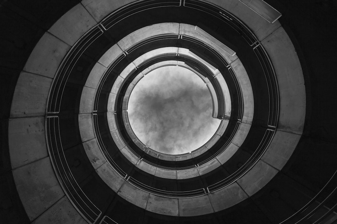 low angle view grayscale photography of spiral building, vortice