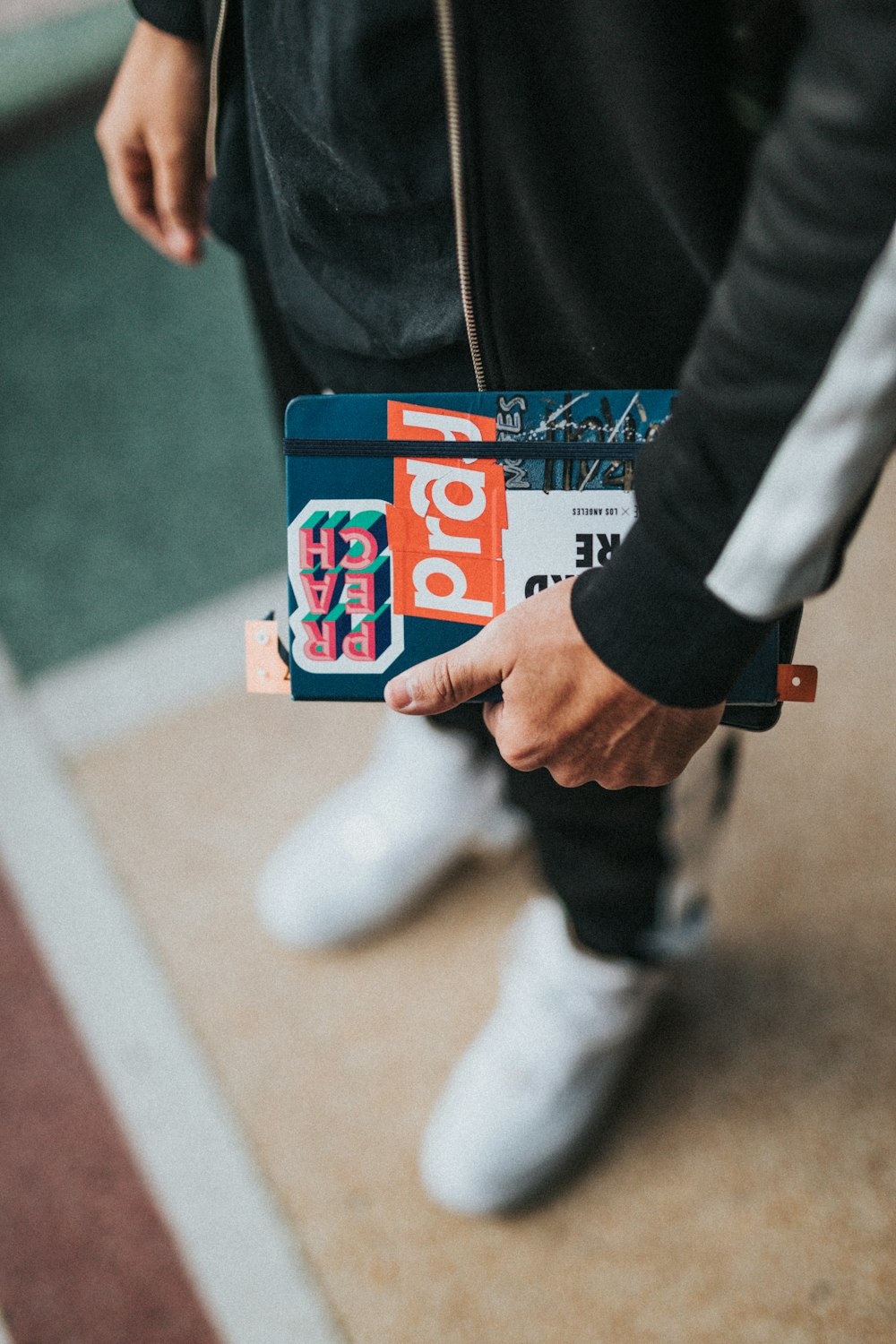 person standing while holding notebook