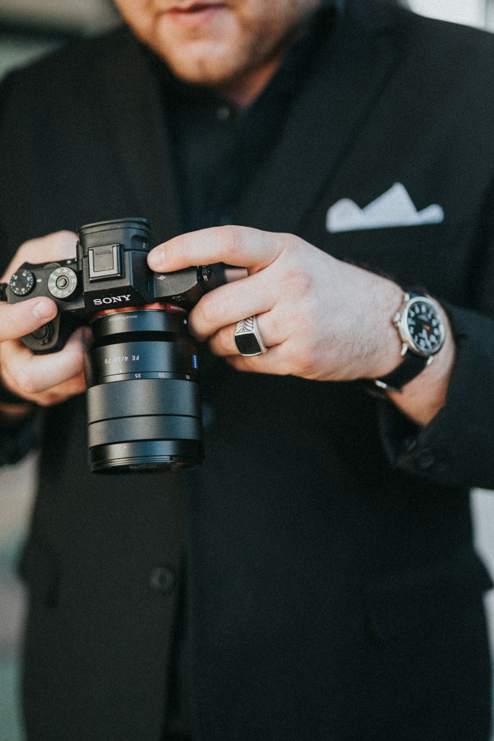 man holding black Sony DSLR camera