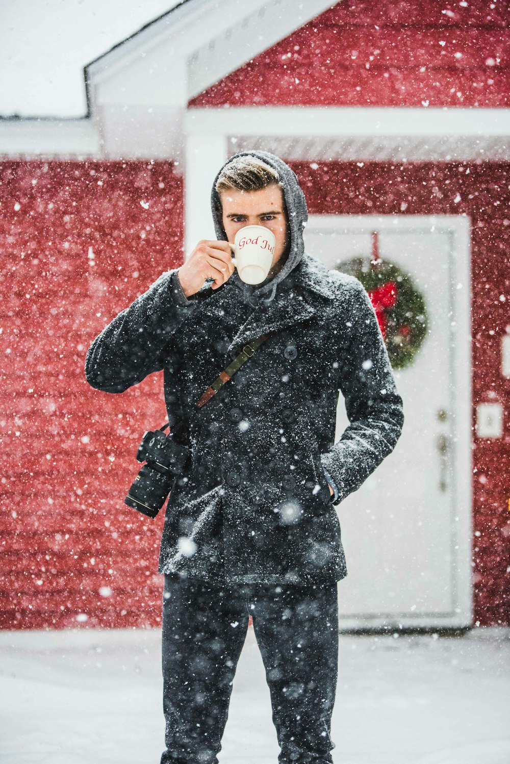 man wearing coat using white mug