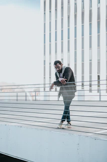 Modern urban scene with someone casually wearing luxury sunglasses on a sunlit balcony
