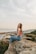 woman sitting on rock during daytime