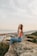 woman sitting on rock during daytime