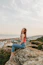 woman sitting on rock during daytime