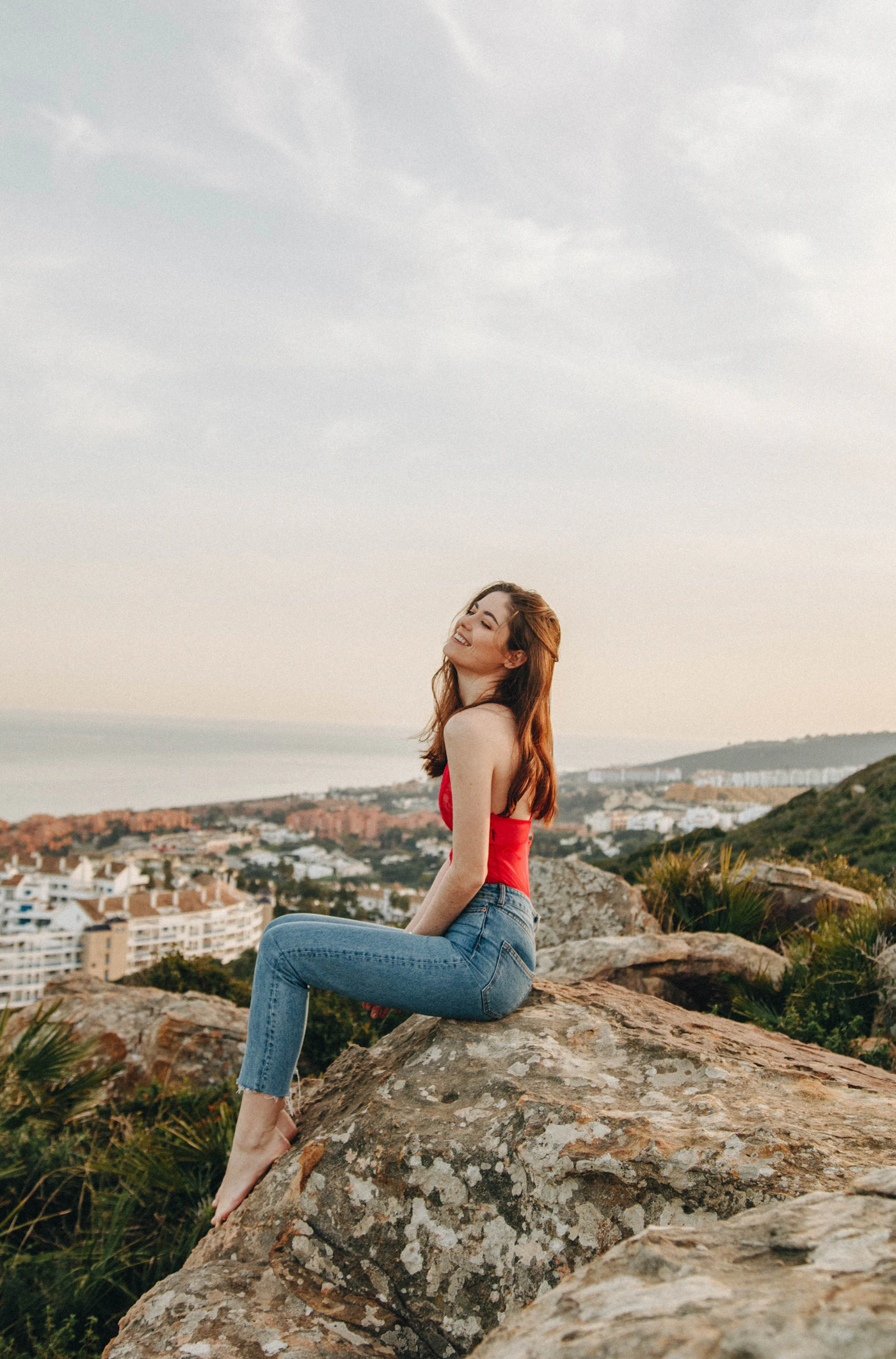 A figure on a coastal ridge at golden hour