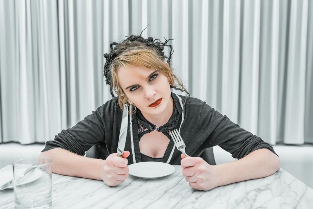 woman holding fork and knife inside room