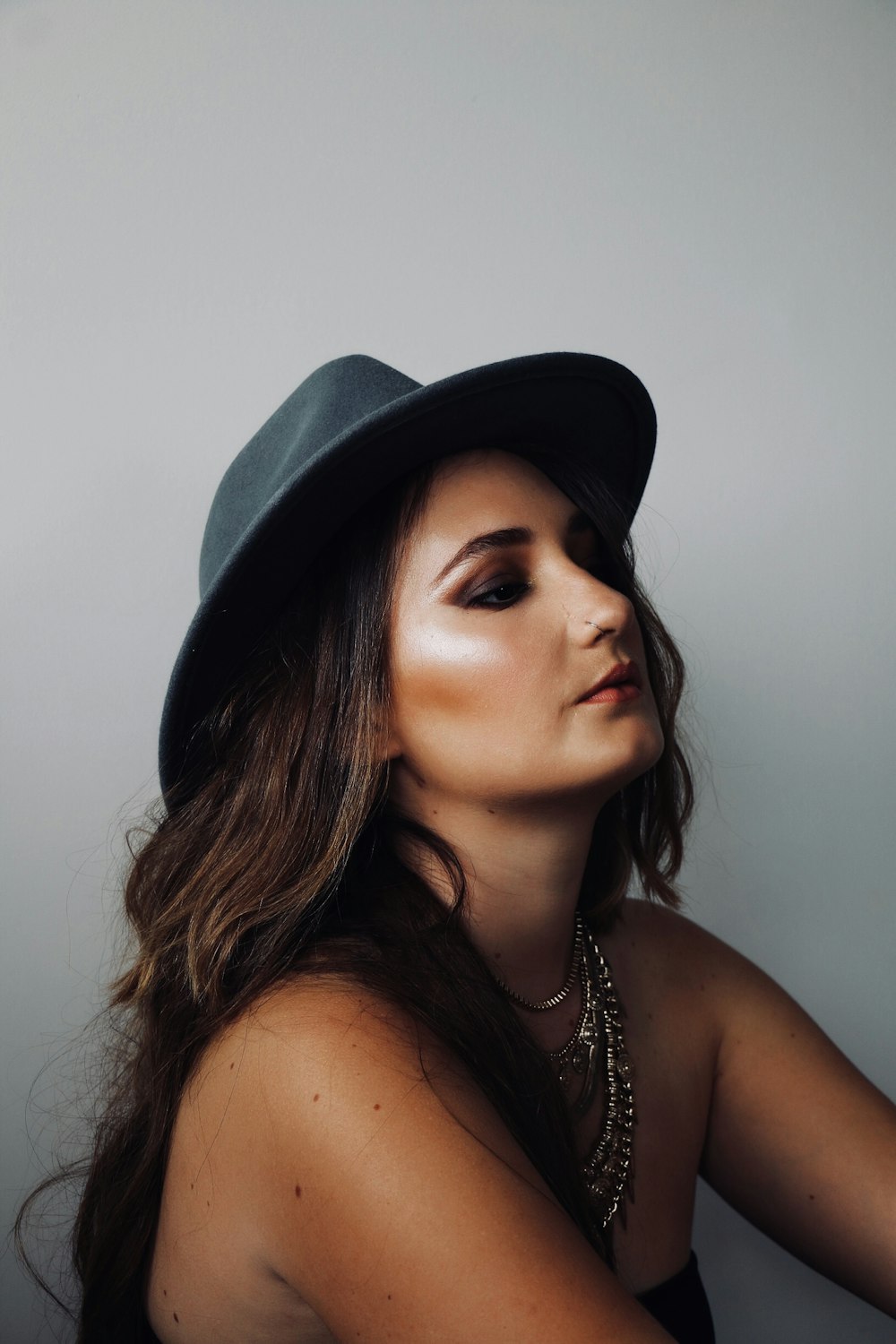 brown haired woman wearing gray hat