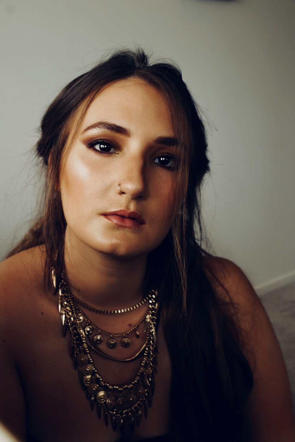 shallow focus photo of woman wearing necklace