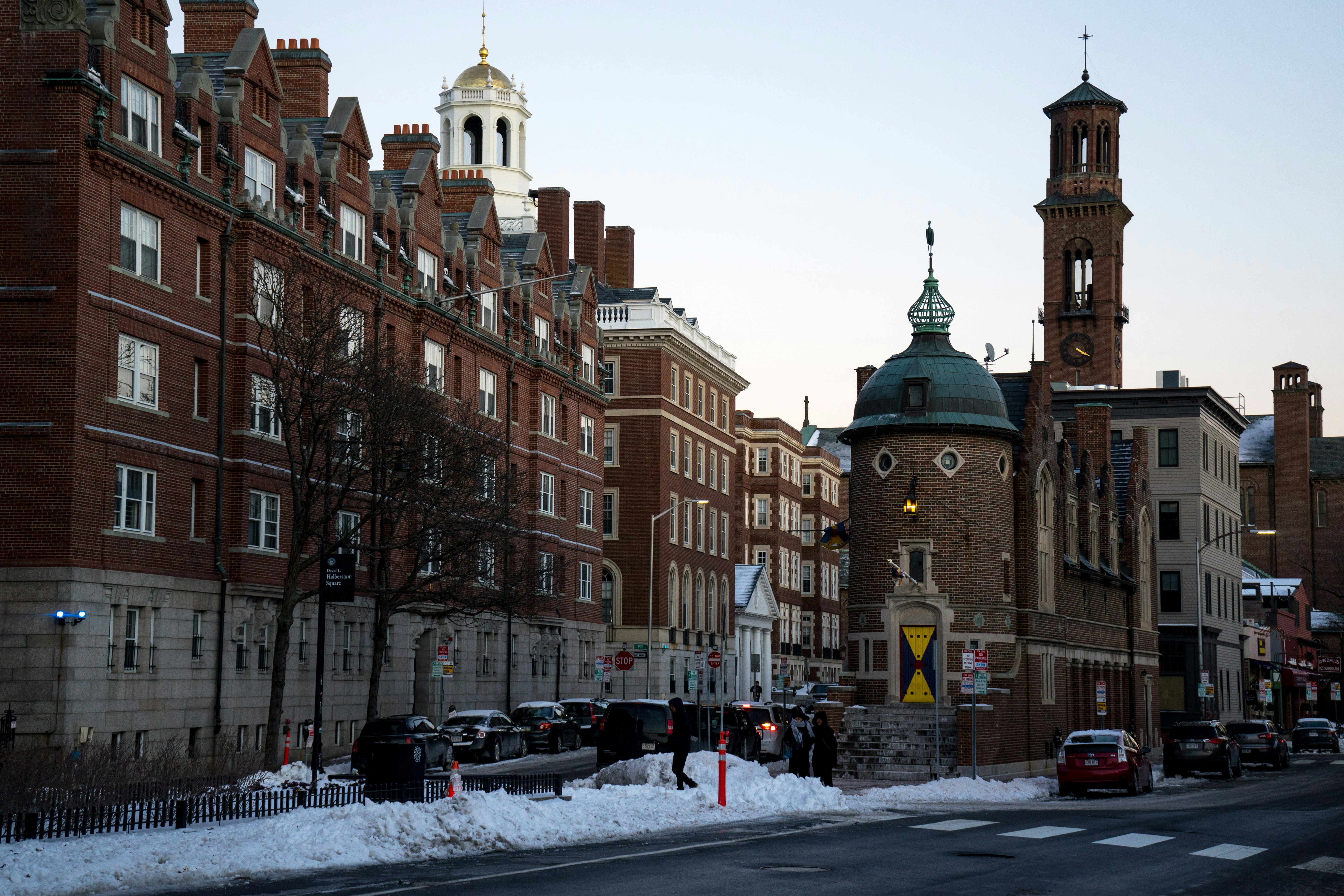 a city street with cars parked on the side of the road