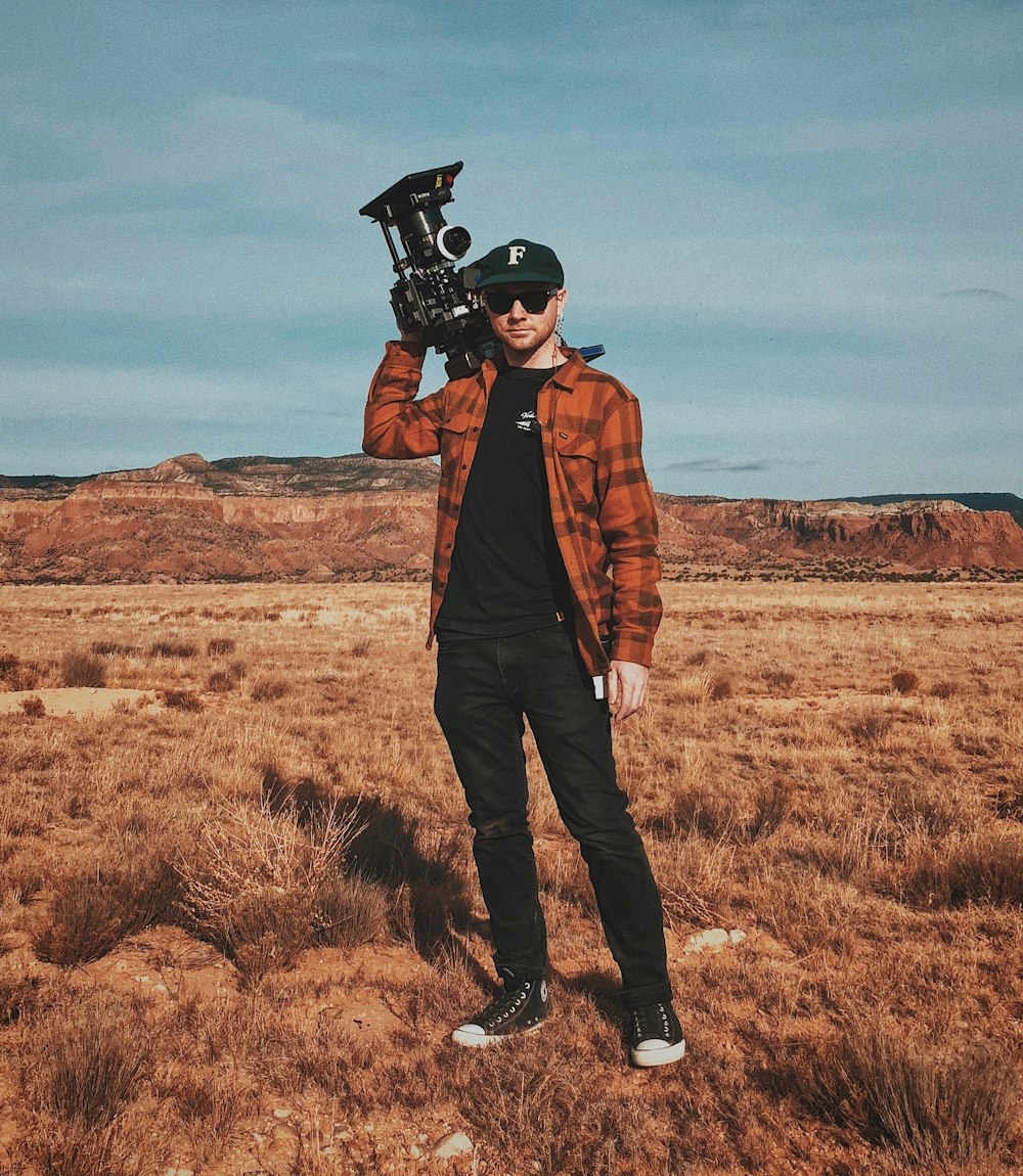 man carrying black industrial machine