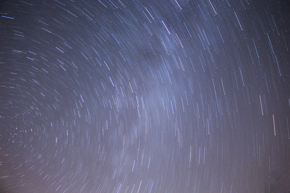 the night sky is filled with star trails