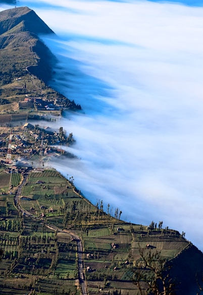 green mountains covered with fog