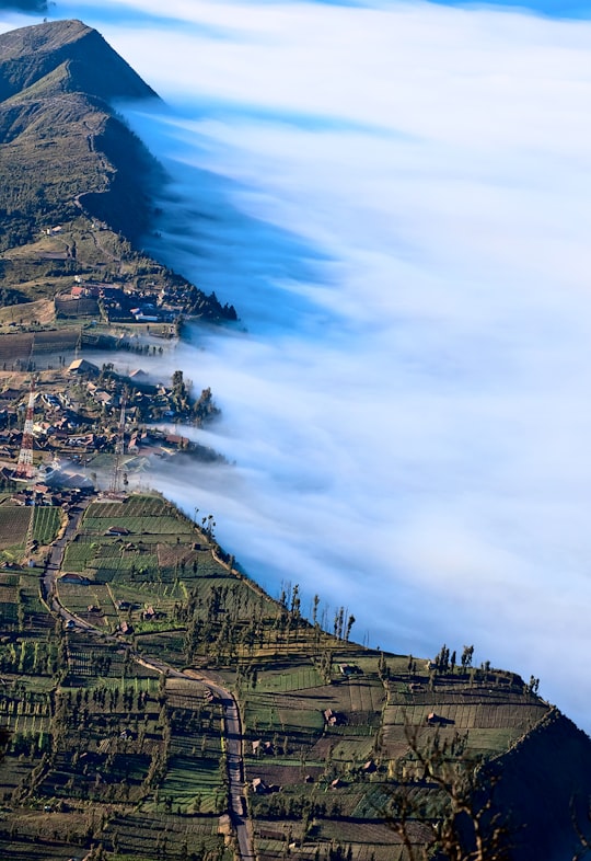 green mountains covered with fog in Bromo Tengger Semeru National Park Indonesia