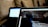 A close-up view of two laptops indoors, displaying a code editor with HTML code on the screen of the laptop in the foreground. The second laptop in the background is out of focus. Both laptops are placed on a cozy couch, creating a casual and comfortable working environment.