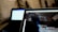 A close-up view of two laptops indoors, displaying a code editor with HTML code on the screen of the laptop in the foreground. The second laptop in the background is out of focus. Both laptops are placed on a cozy couch, creating a casual and comfortable working environment.