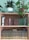 Close-up image of elegant reclaimed hardwood shelves filled with books and plants