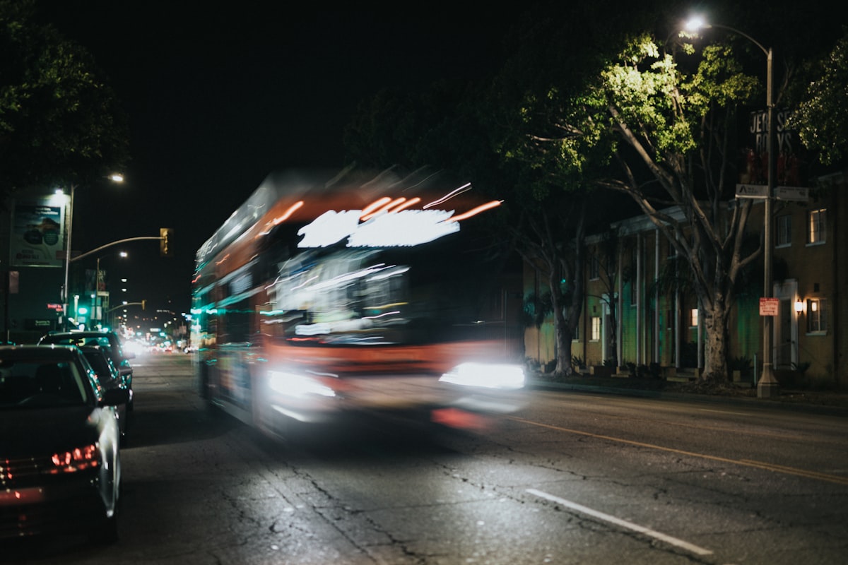 motion blurred city bus on a night time street