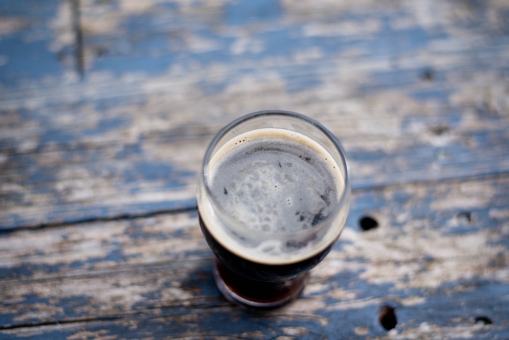 clear drinking glass on blue and white wooden surface