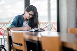 woman writing on book
