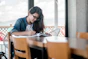 woman writing on book
