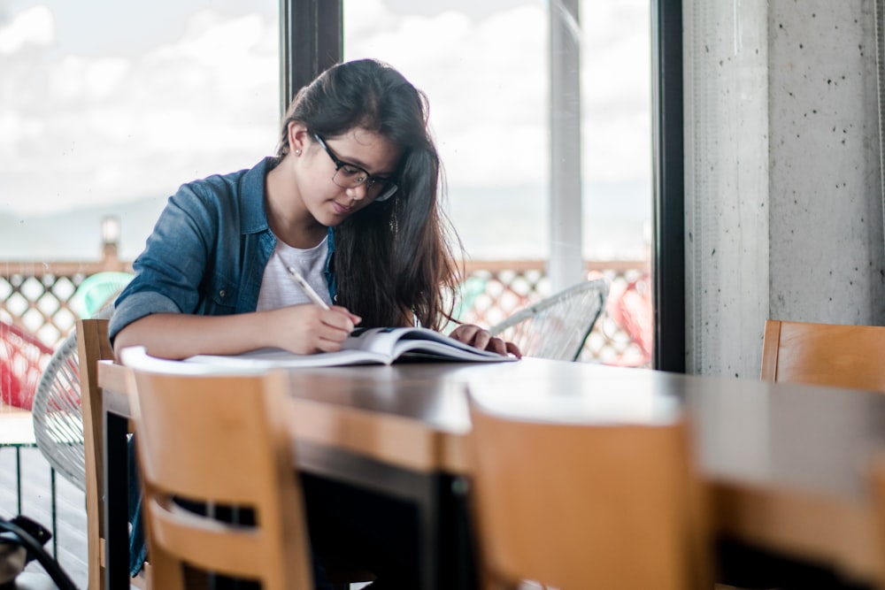 woman writing on book