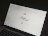 A close-up of a laptop displaying a motivational quote.