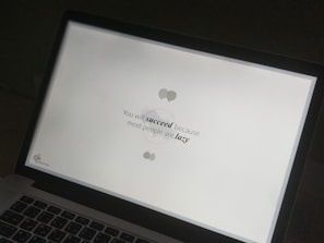 A close-up of a laptop displaying a motivational quote.