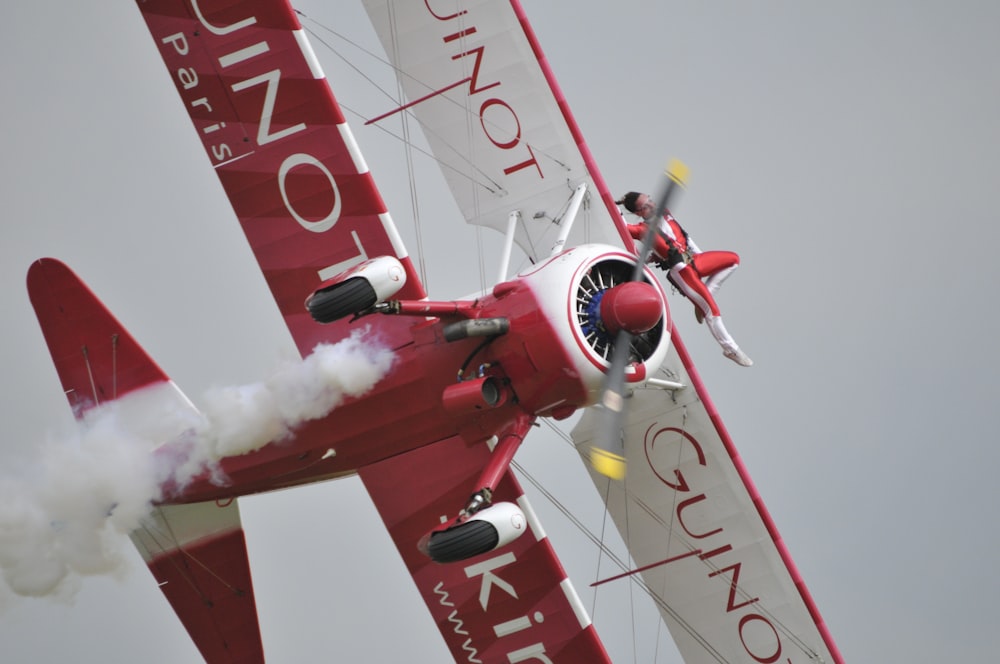 white and red propeller plane