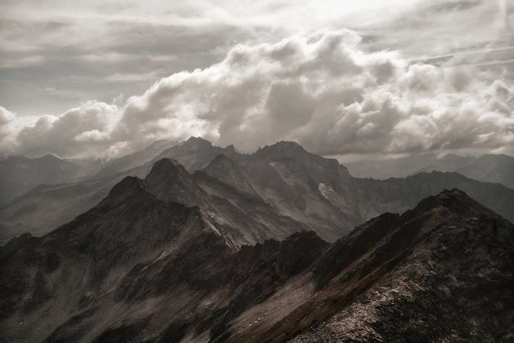 white clouds above mountains during daytime