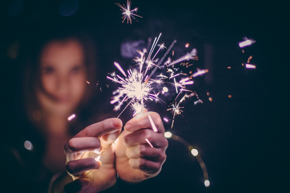 a person holding a sparkler in their hand