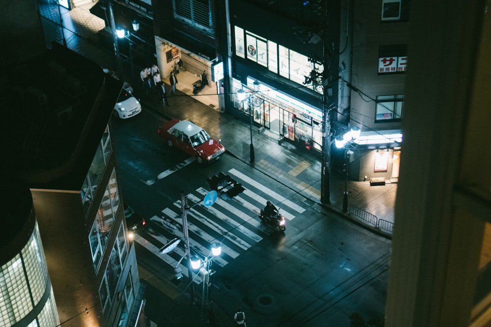 man riding motorcycle on road pedestrian lane during nighttime