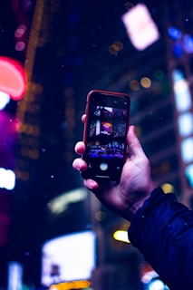 A dynamic shot of a smartphone being used in a bustling city.