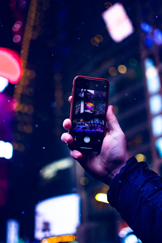 A vibrant cityscape at night with glowing smartphone screens showing Snapchat chats.