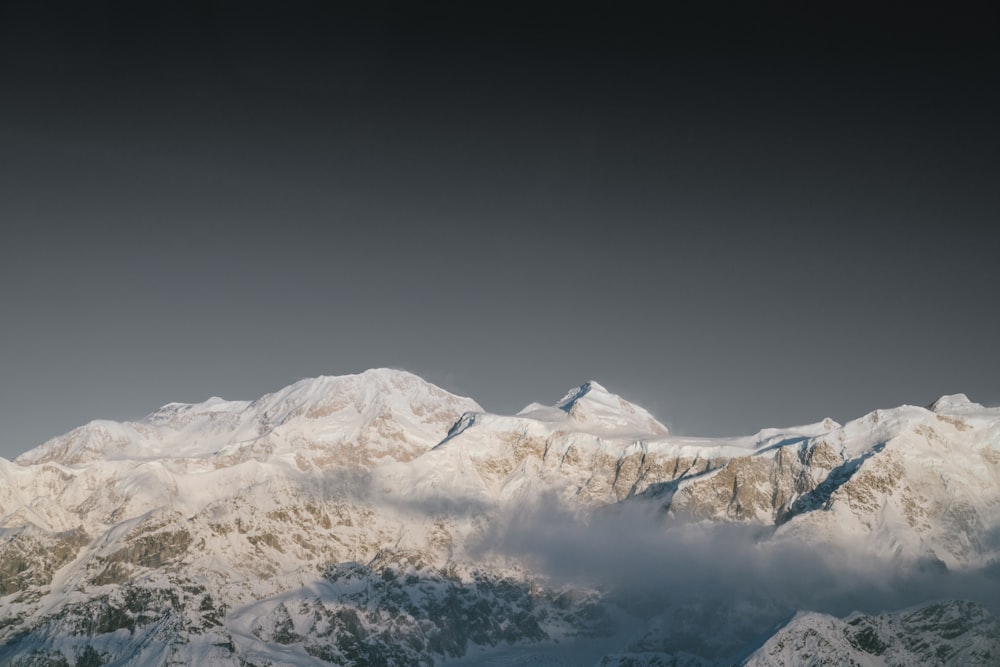 mountain range covered with white snow