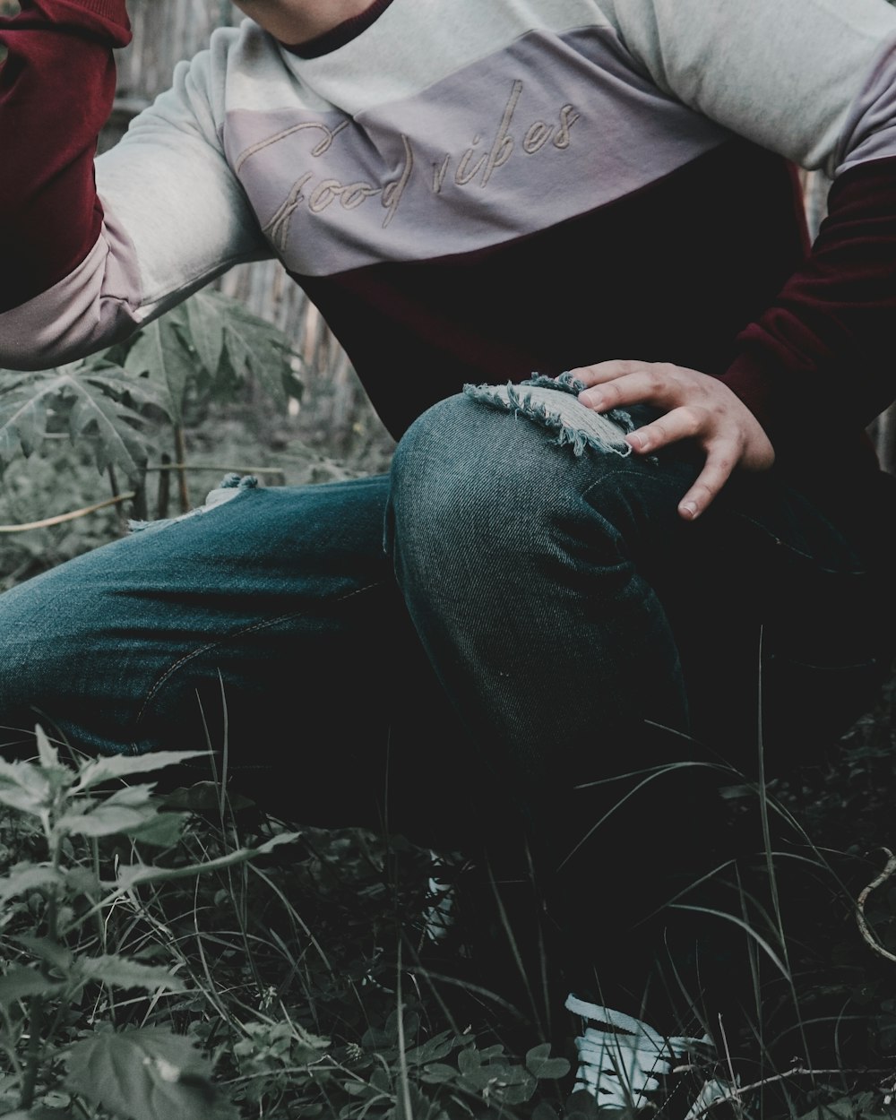 man sitting on green grass field