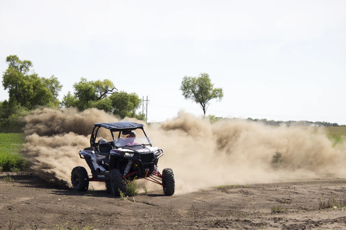 Off-road vehicle drifting on a dusty field