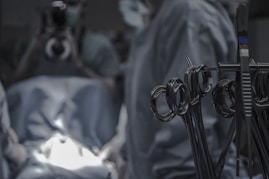 gray surgical scissors near doctors in operating room