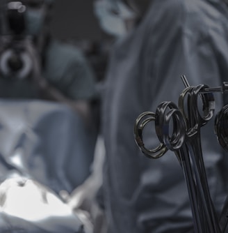 gray surgical scissors near doctors in operating room