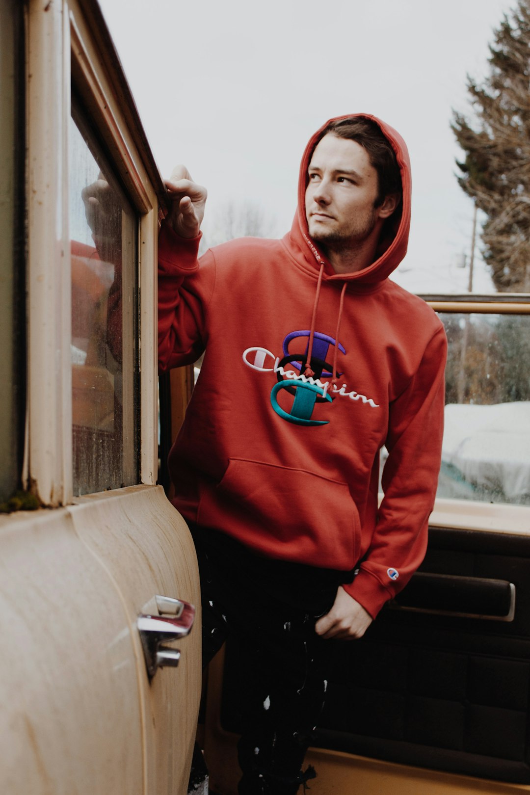 man wearing red Champion brand hoodie