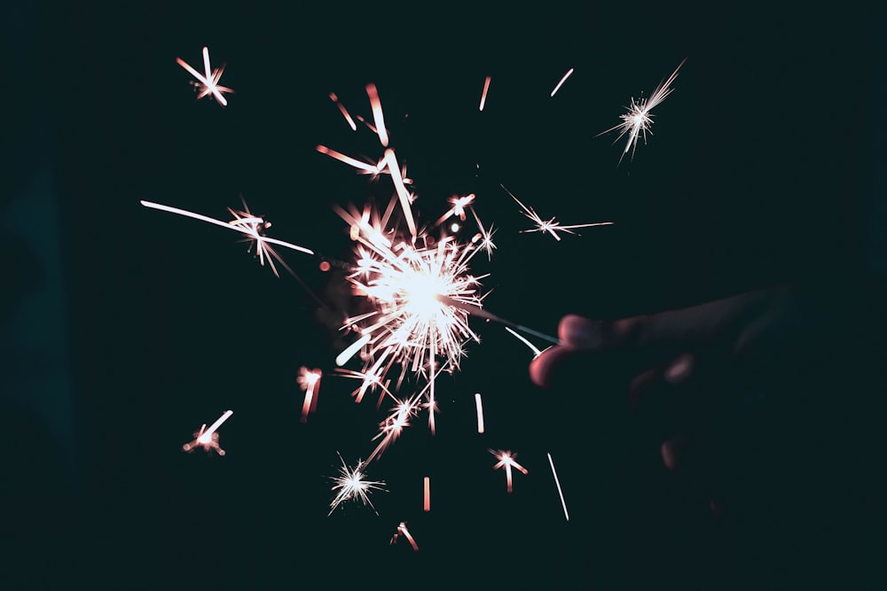 person holding sparkling light