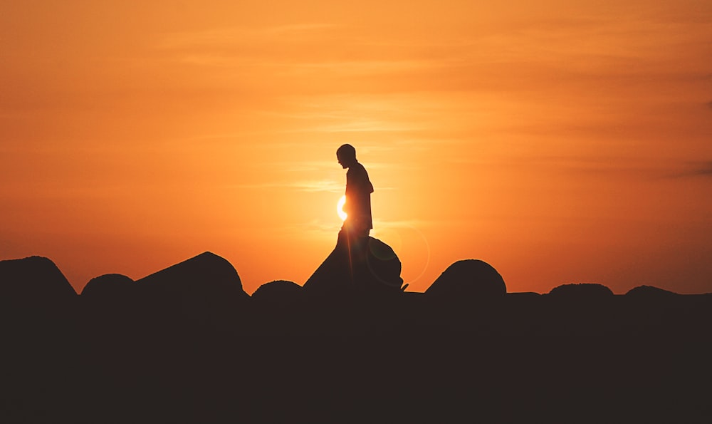 person standing on rock platform