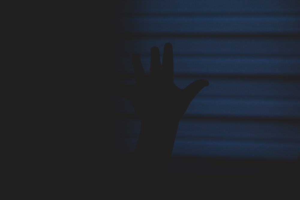 a person's hand reaching up into the air