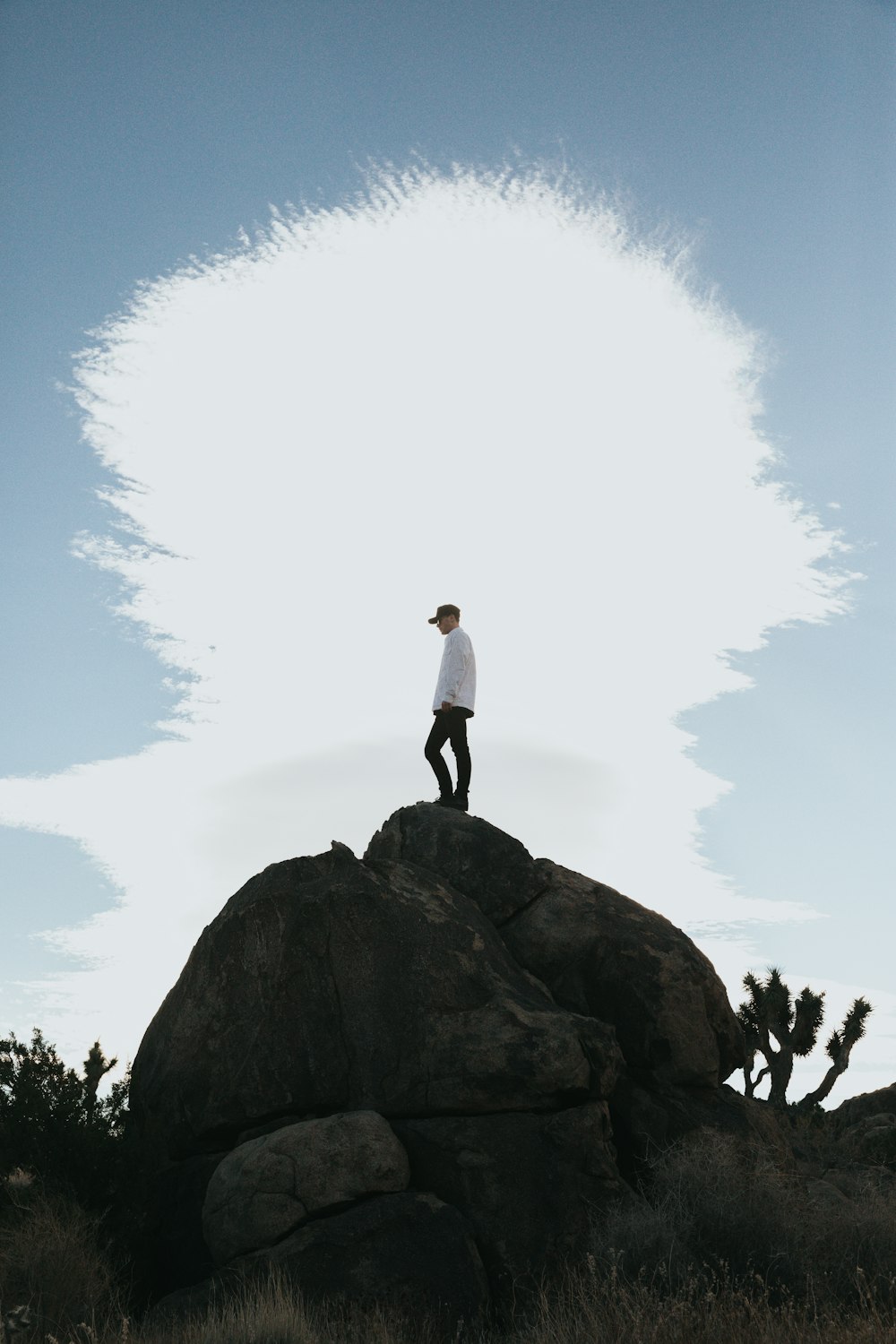 man standing on rock during daytime
