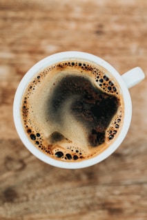 white ceramic mug filled with coffee