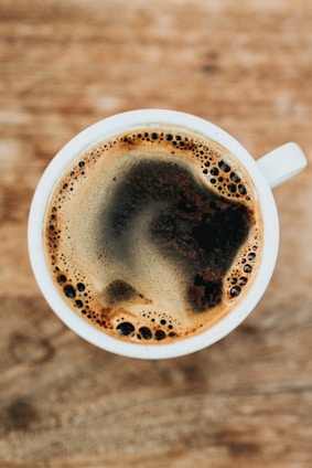 white ceramic mug filled with coffee