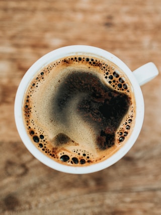 white ceramic mug filled with coffee