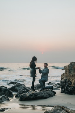 the knee,how to photograph man kneeling in front of woman on rock at beach