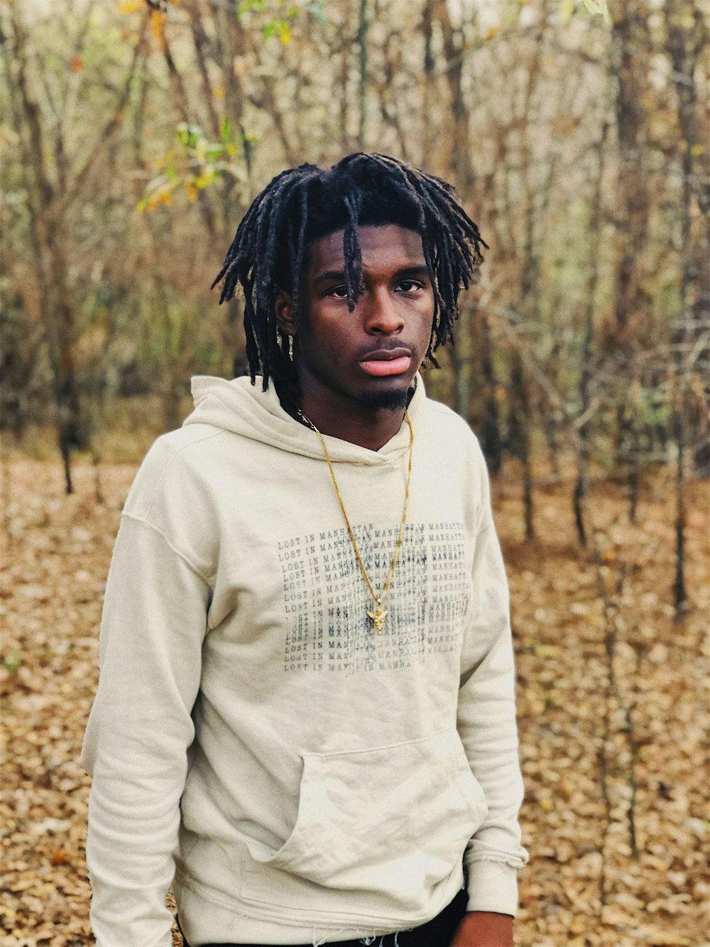 selective focus of man standing between trees