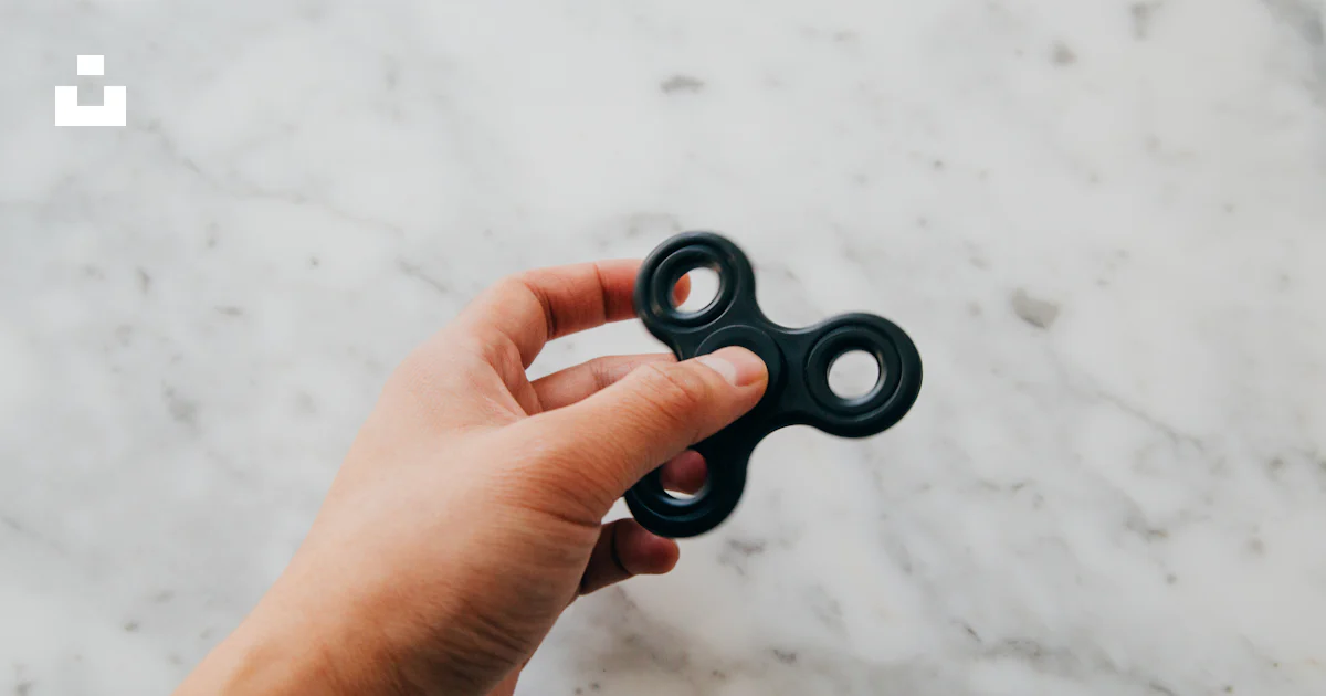 Person using black fidget spinner photo – Free Toy Image on Unsplash